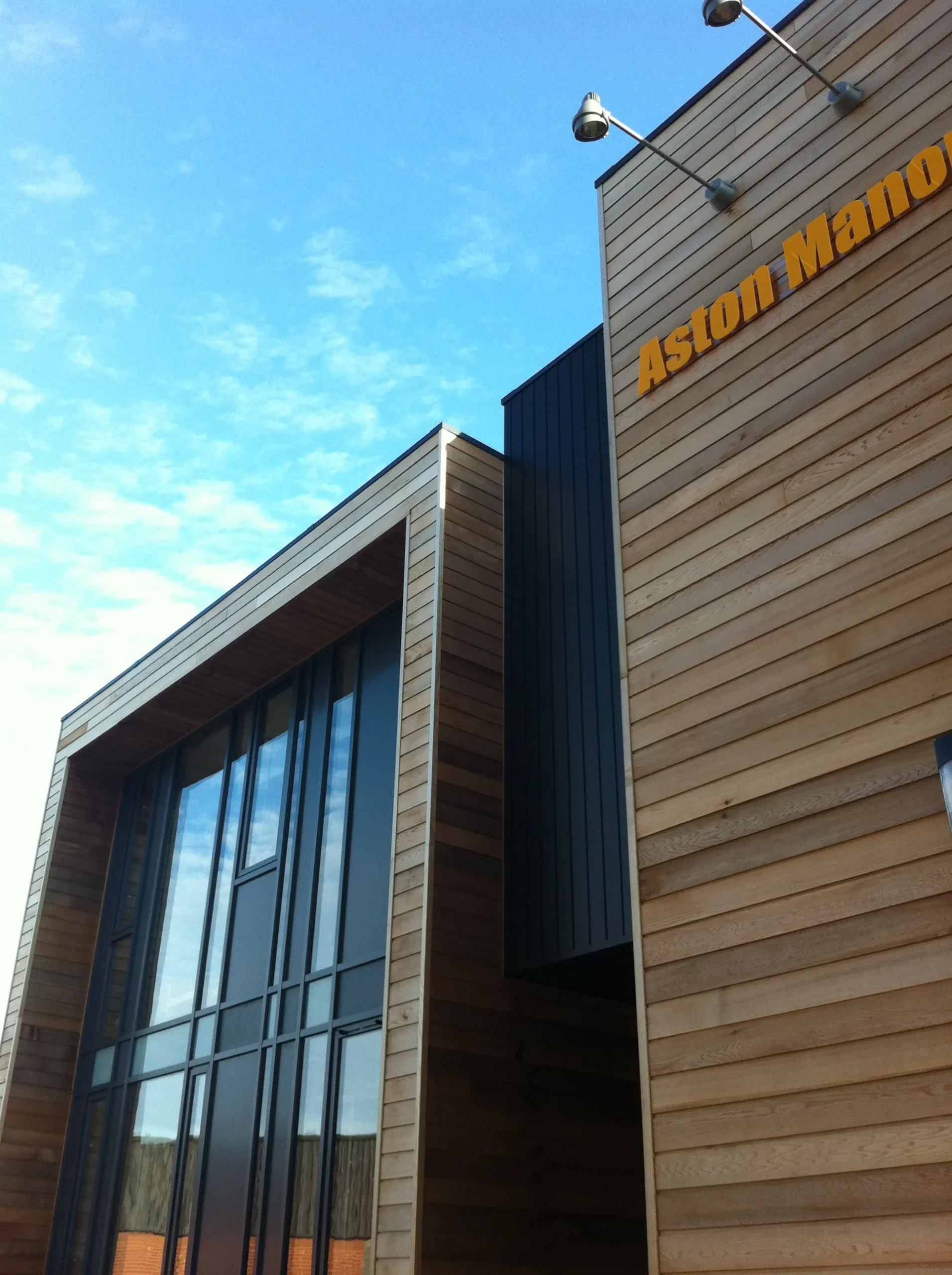 Black timber cladding denotes entrance located between glazed classrooms and timber clad stairwell