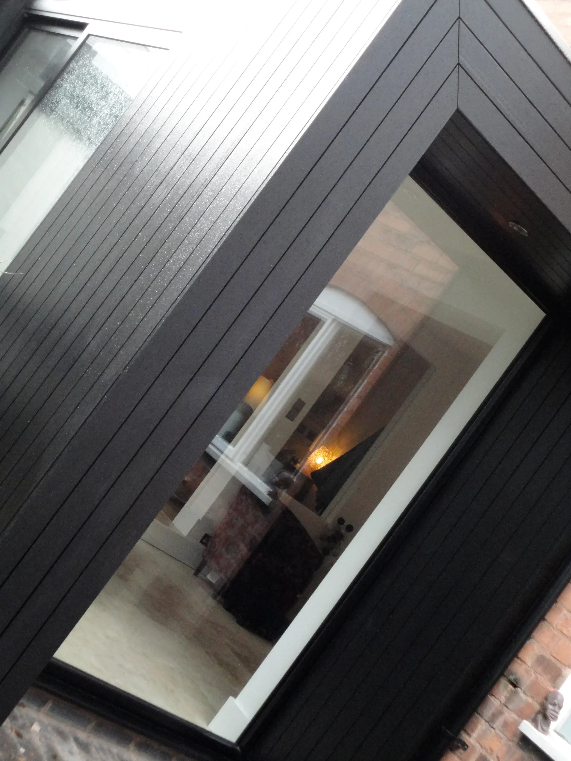 Black stained timber clad and black framed windows