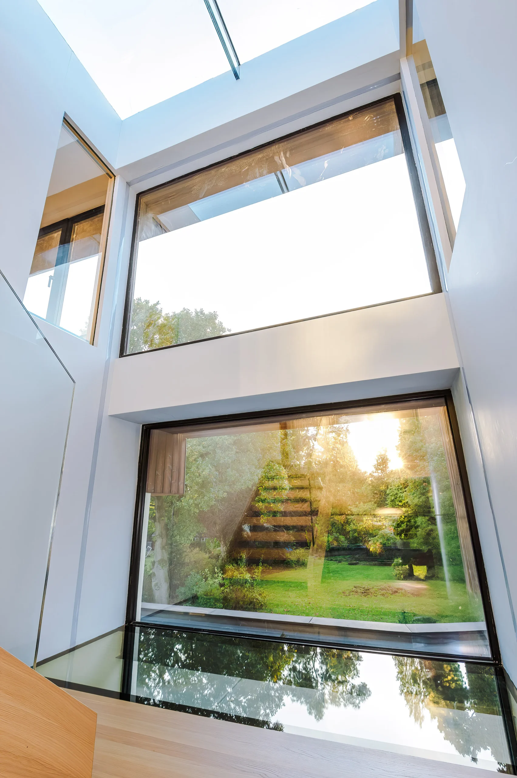 Loft stairwell with glazing to the floor, roof, internal walls and outside garden wall.