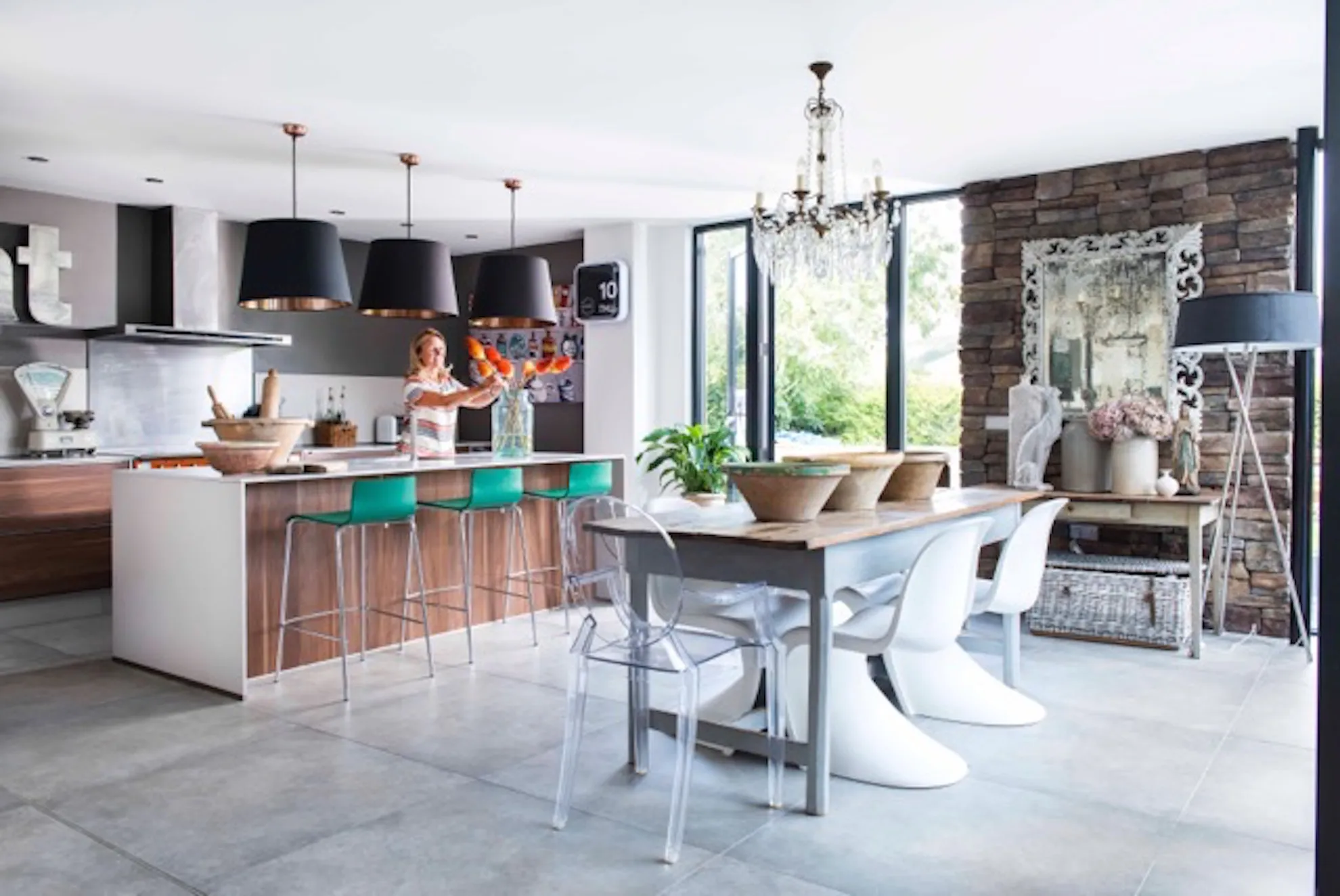 Open plan kitchen with breakfast bar island linking to dining