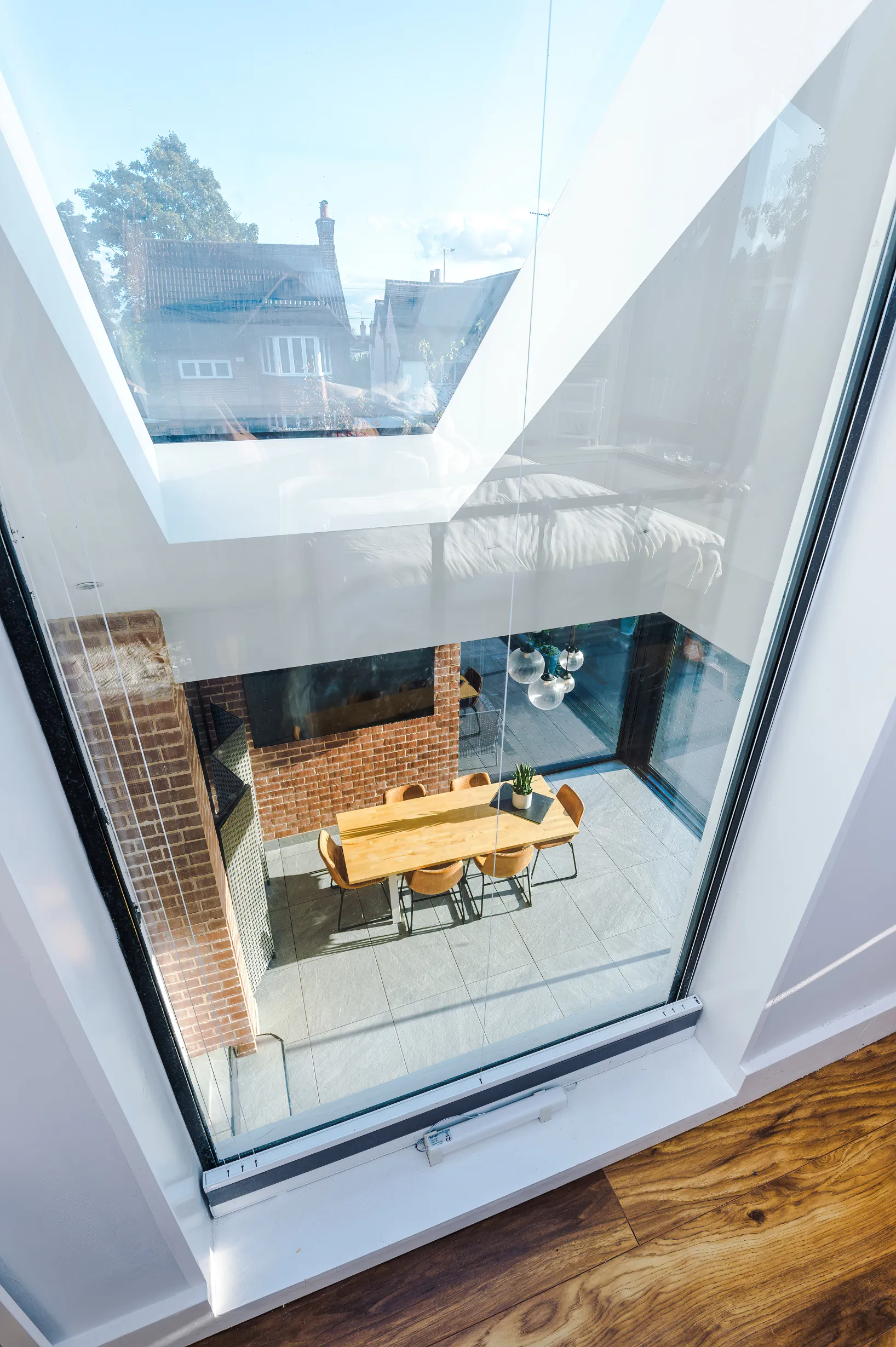 View through internal window looking down into open plan space