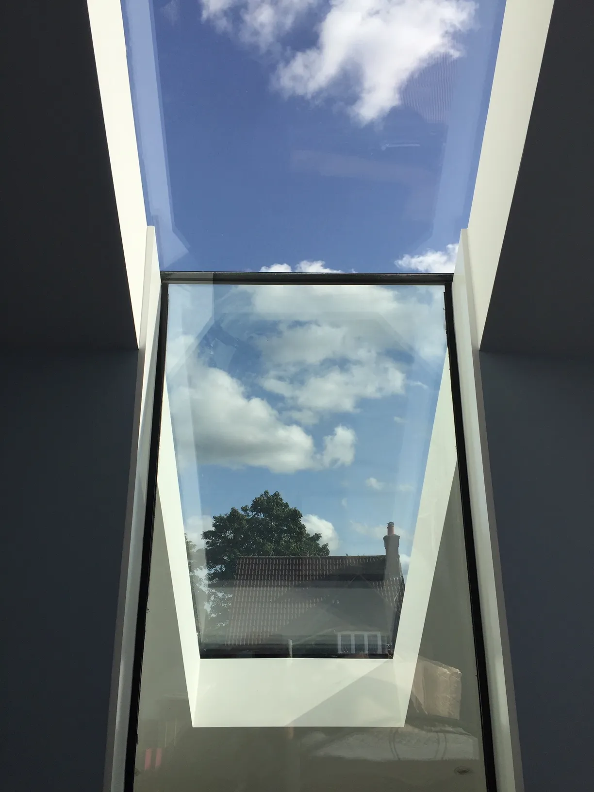 Rooflight and internal window meet over double height space