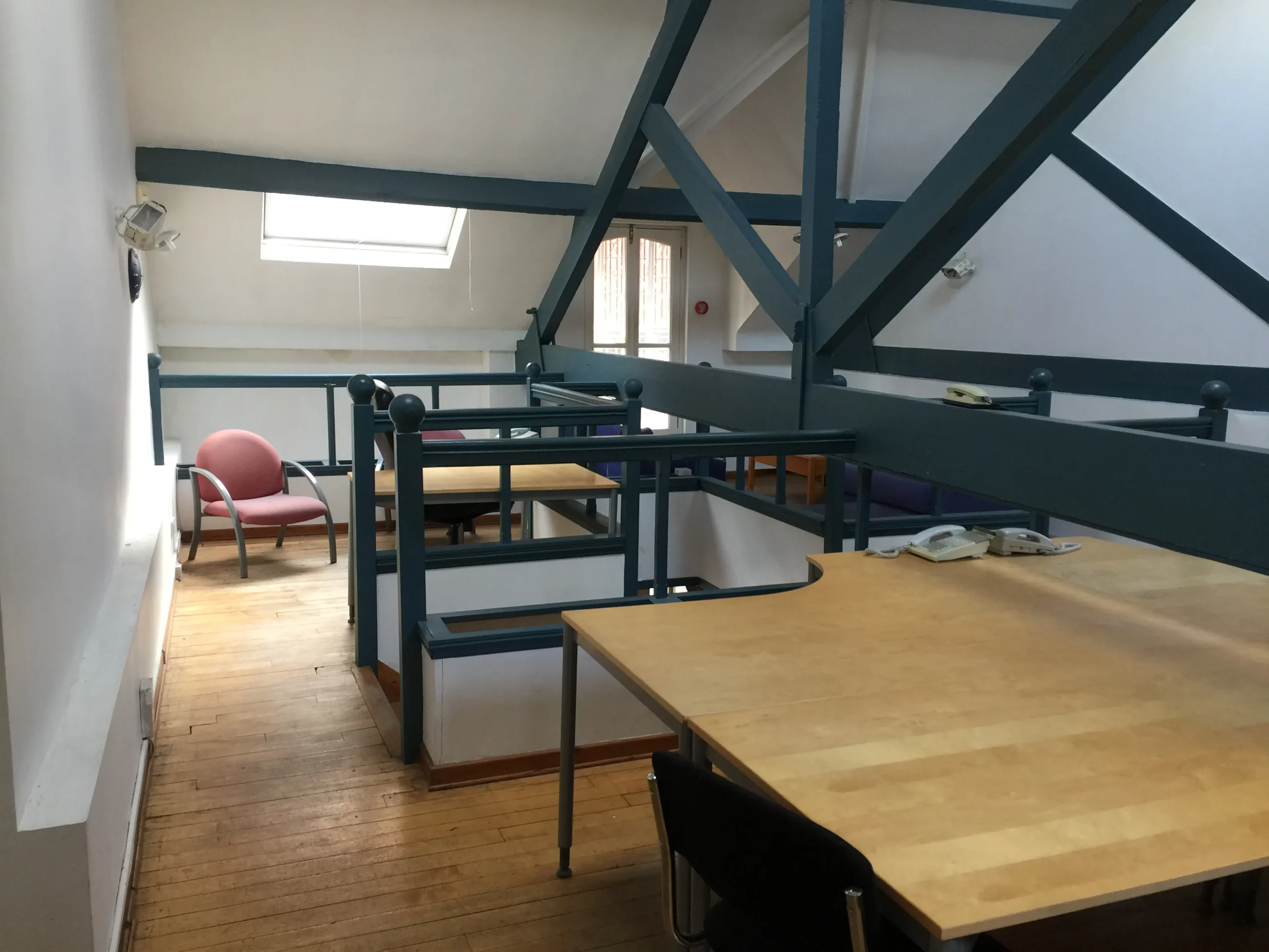 ‘Before’ photograph showing the roof truss dissecting the office space at first floor