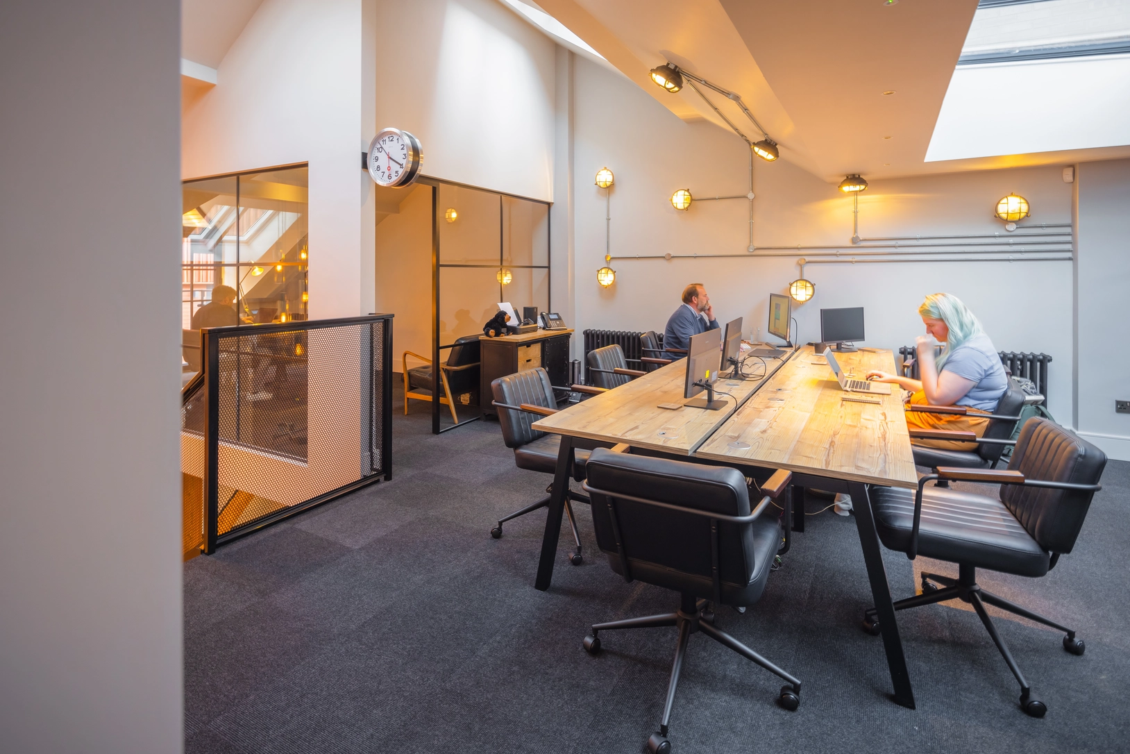 Workstations within open plan space on the first floor, with new rooflights. The directors’ office in the background with crittall style glazing.