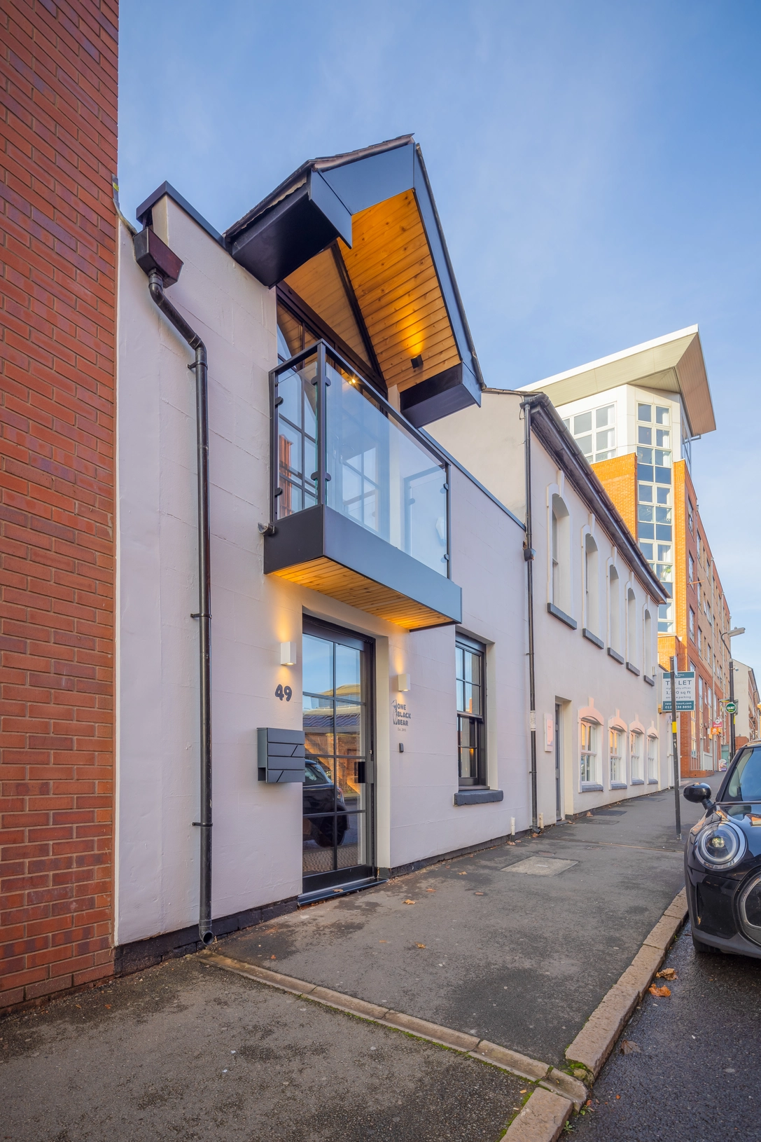 Rejuvenated elevation with re-shaped dormer and balcony, and new render application