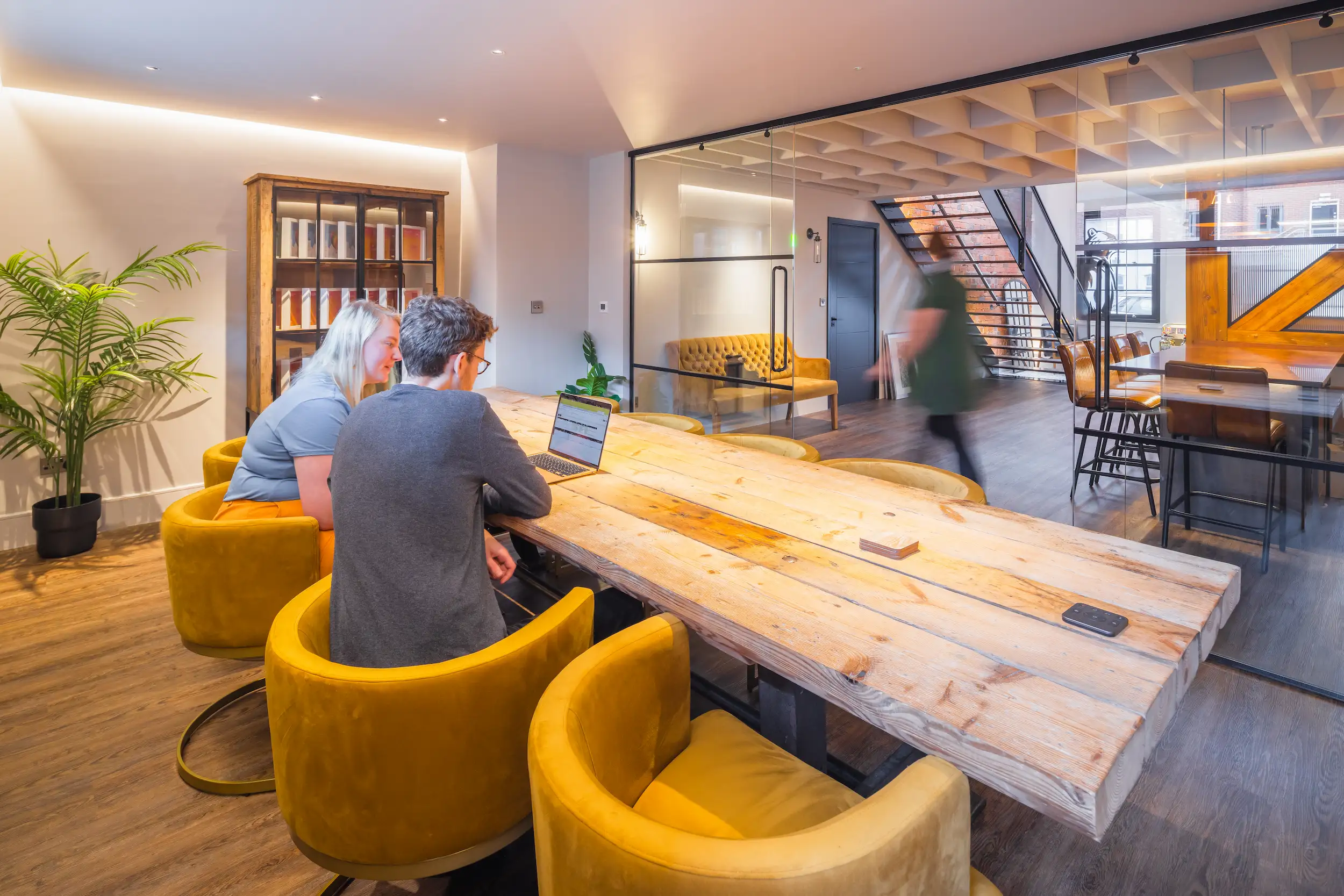 Conference room is separated from the open plan space by a crittall style glazed screen.