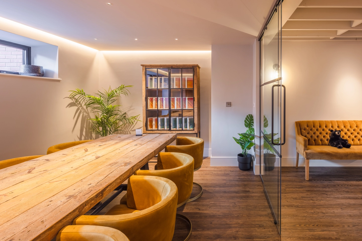Conference room is separated from the open plan space by a crittall style glazed screen.