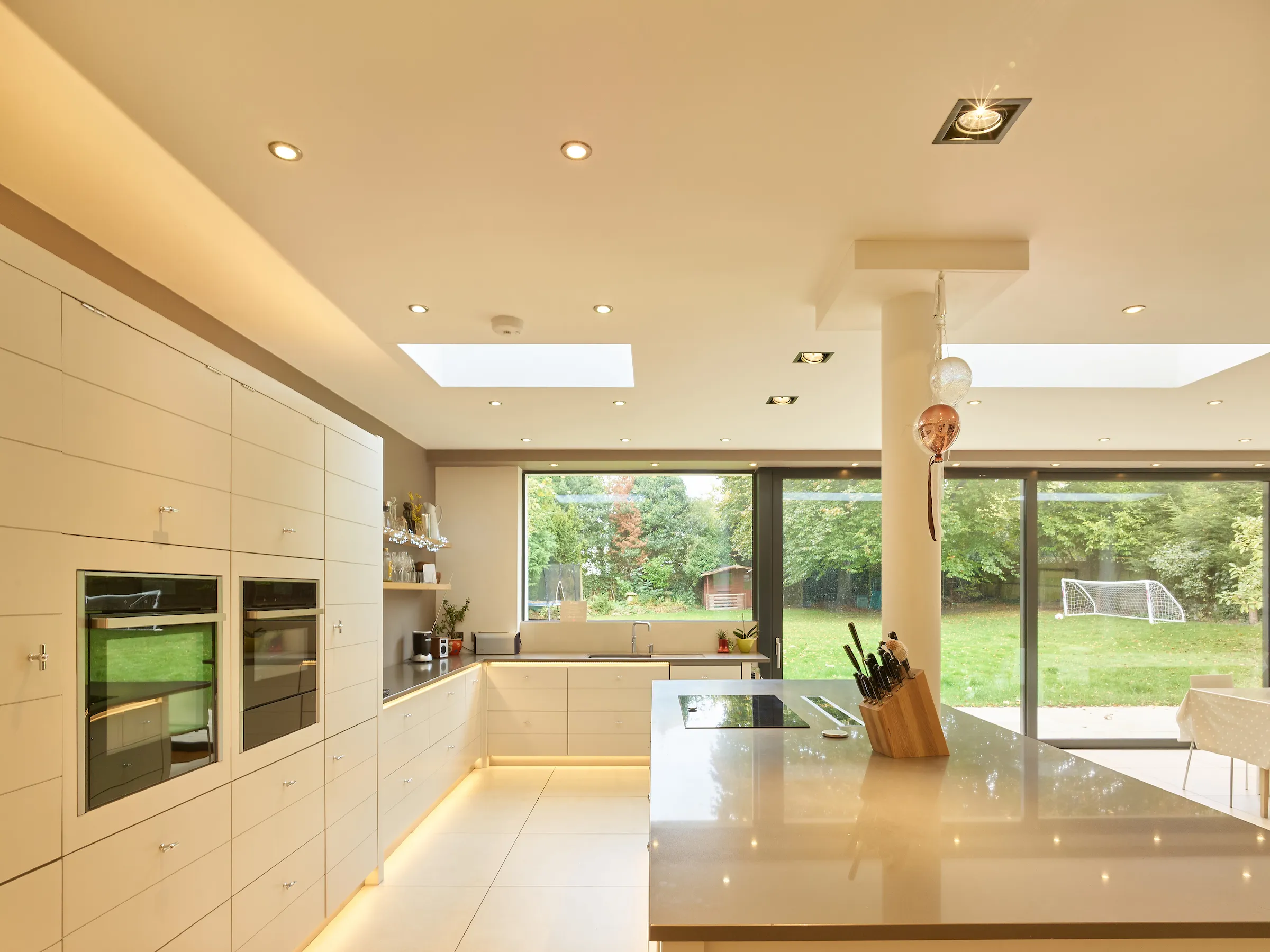 Open plan kitchen with kitchen island and linking to dining
