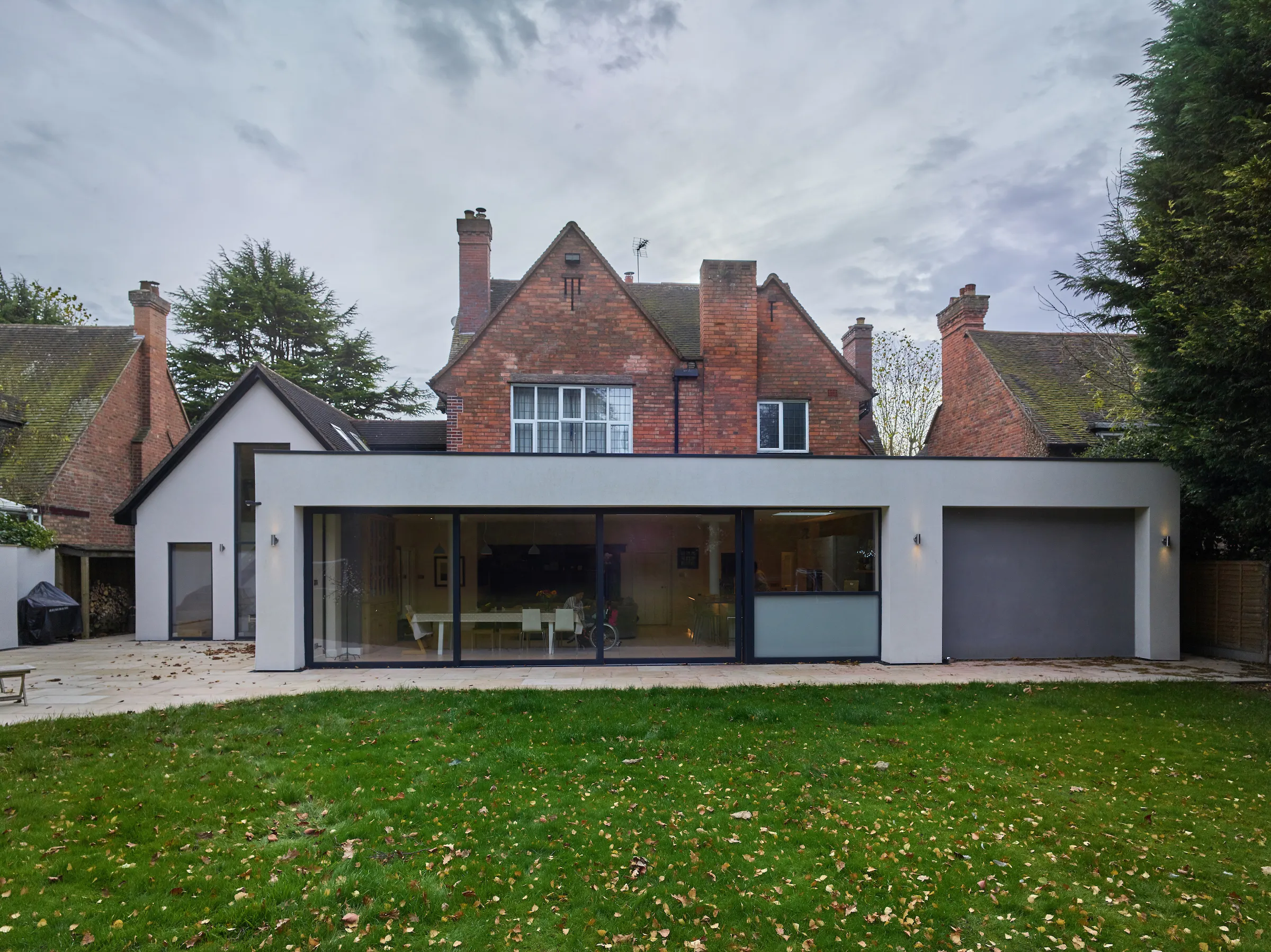 Rendered rear extension with sliding doors, and repurposed annexe