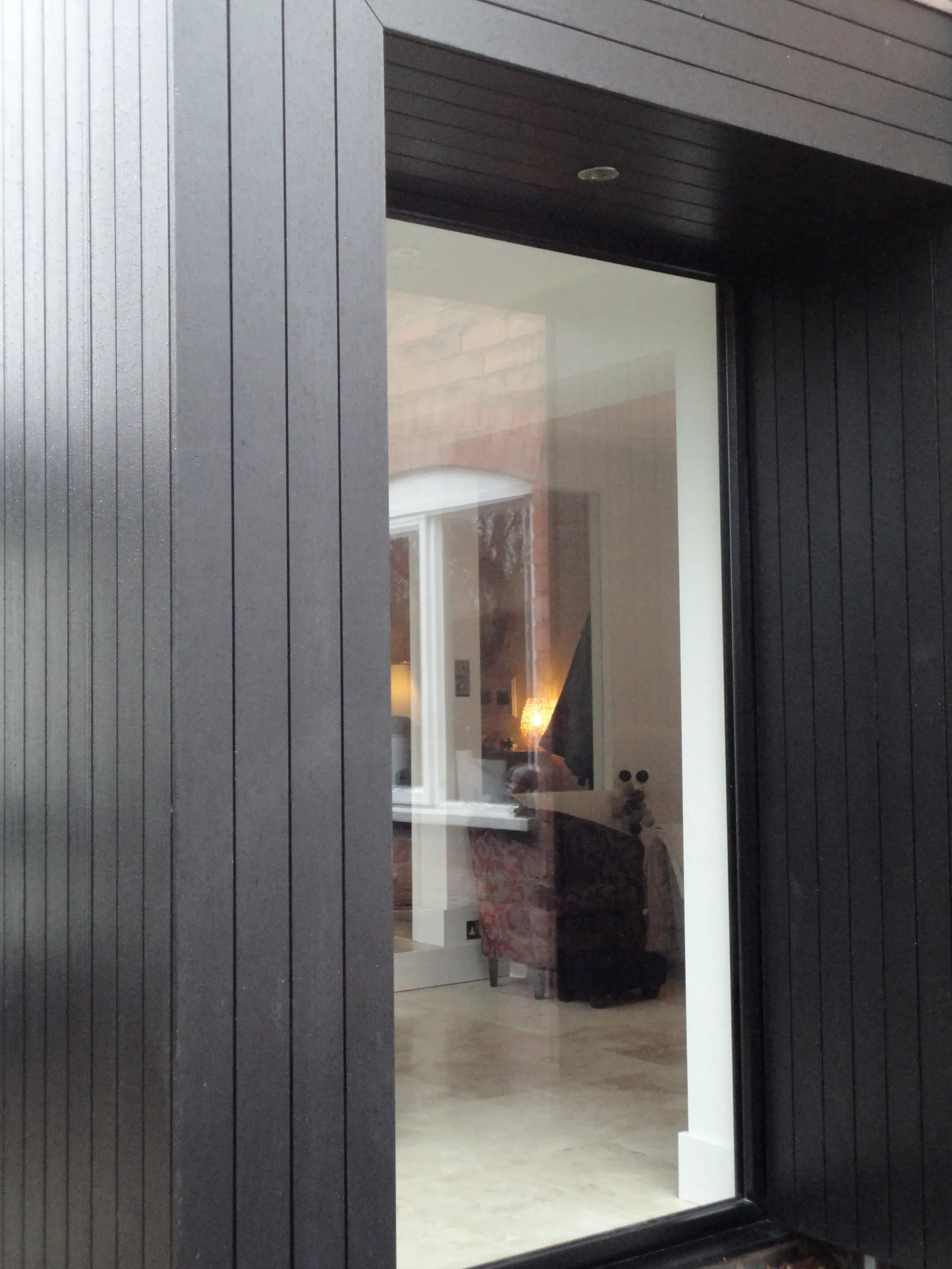 Black stained timber clad and black framed windows