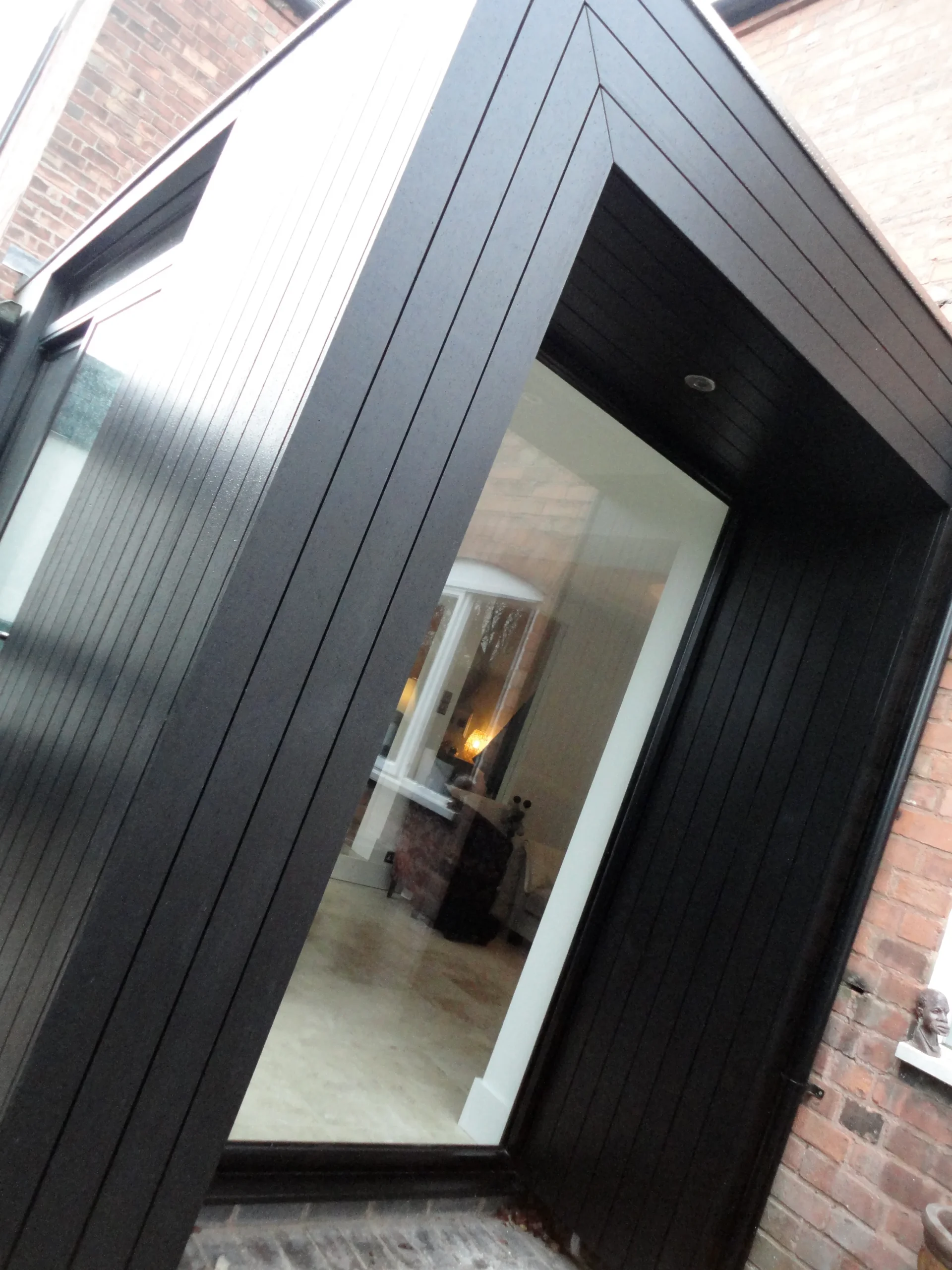 Timber cladding stained black with mitred joints