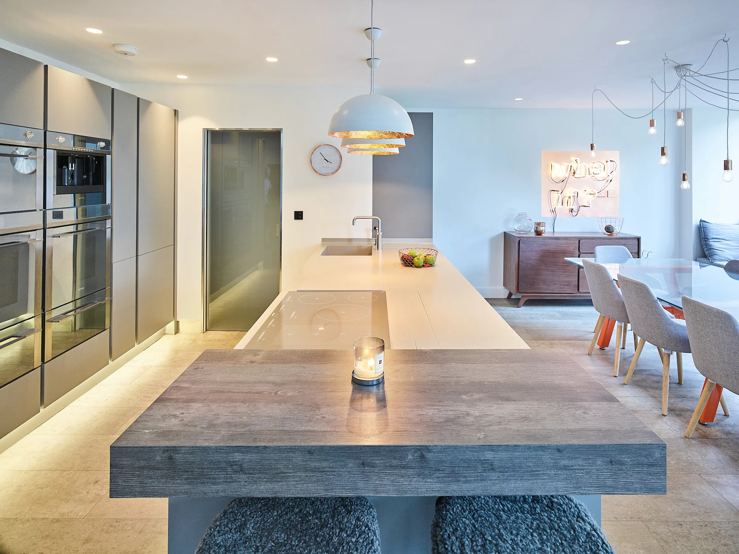 Open plan kitchen with breakfast bar, liking with dining area