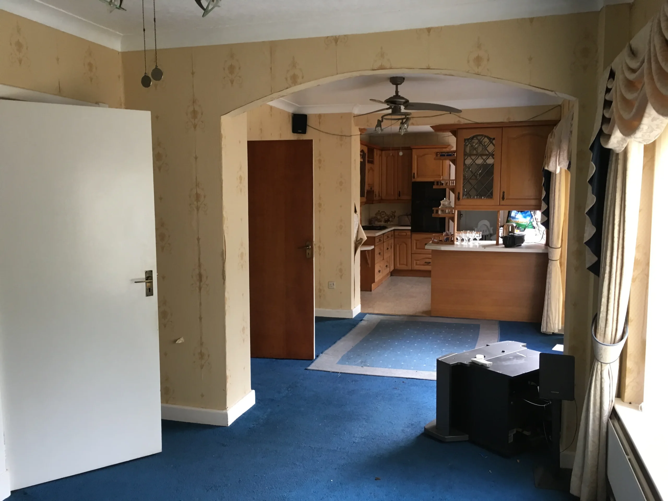 ‘Before’ photograph of a view from the dining room into the kitchen