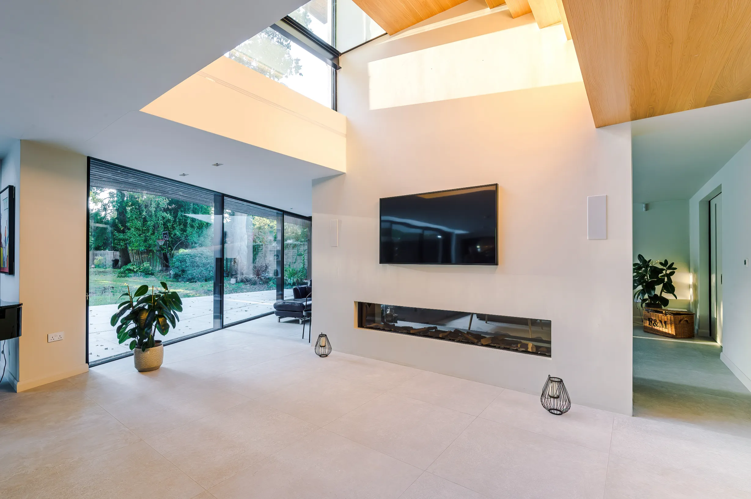 View of the multi-zone space featuring the underbelly of the loft stair with glazed landing floor, and lounge beyond