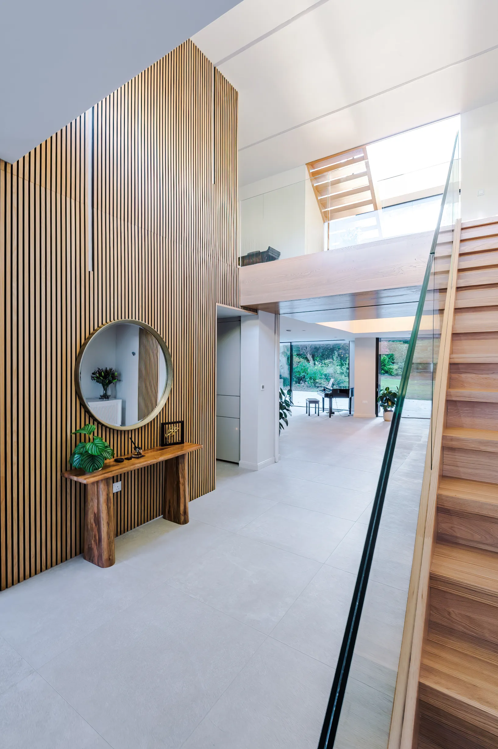 View of the double height entrance foyer with feature timber cladding and a glimpse of the loft stair beyond