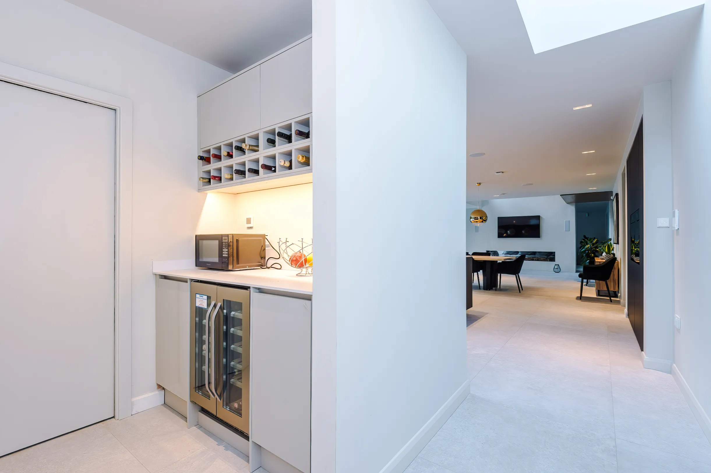 The ‘open utility’ is spatially linked to the open plan space, but concealed from view. The ‘closed utility’ is accessed through the door to the left.