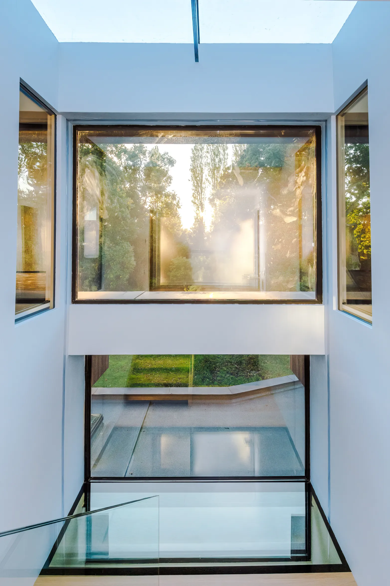 Loft stairwell with glazing to the floor, roof, internal walls and outside garden wall.