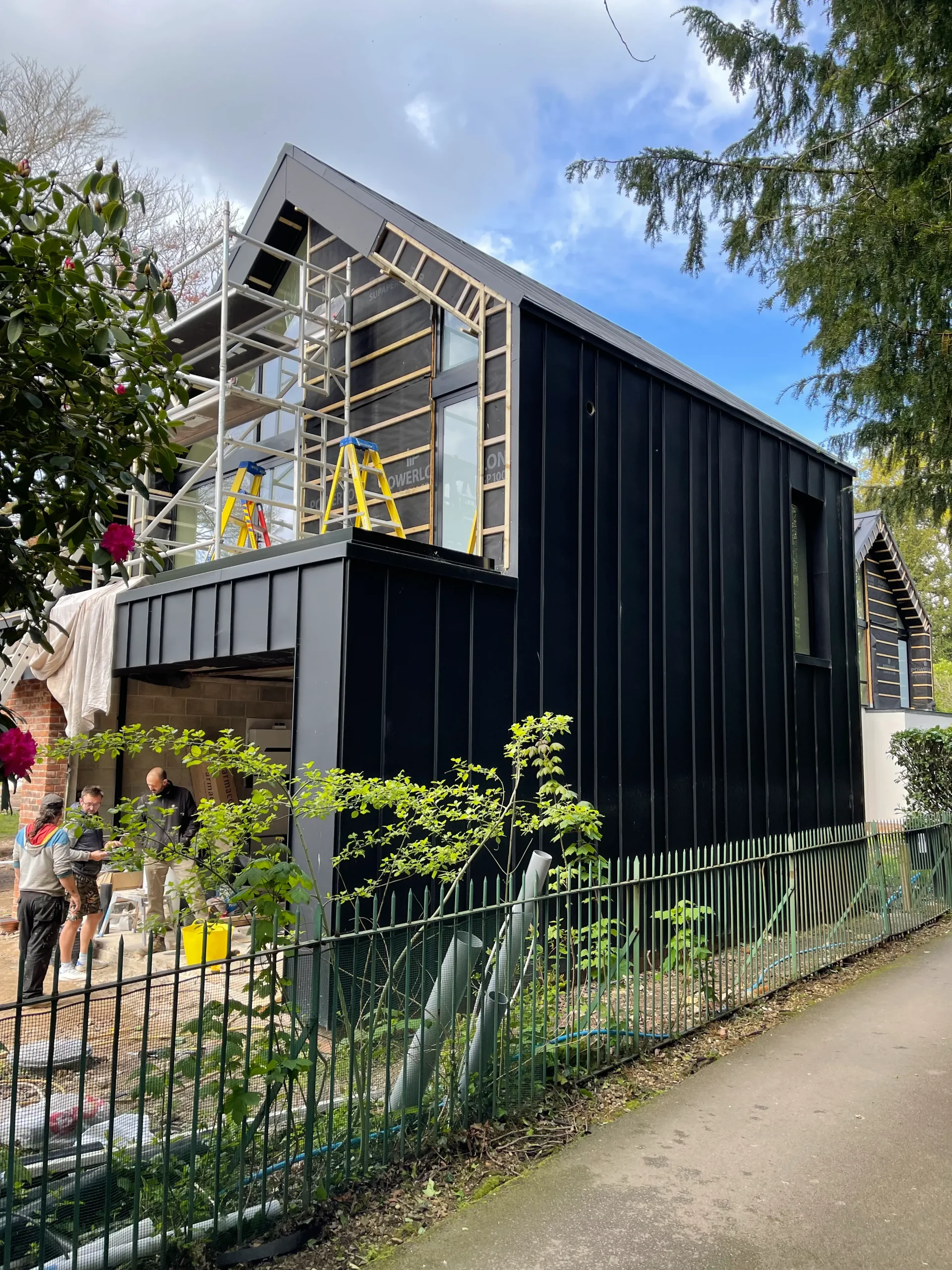 Side view showing zinc cladding wrapping down to ground level