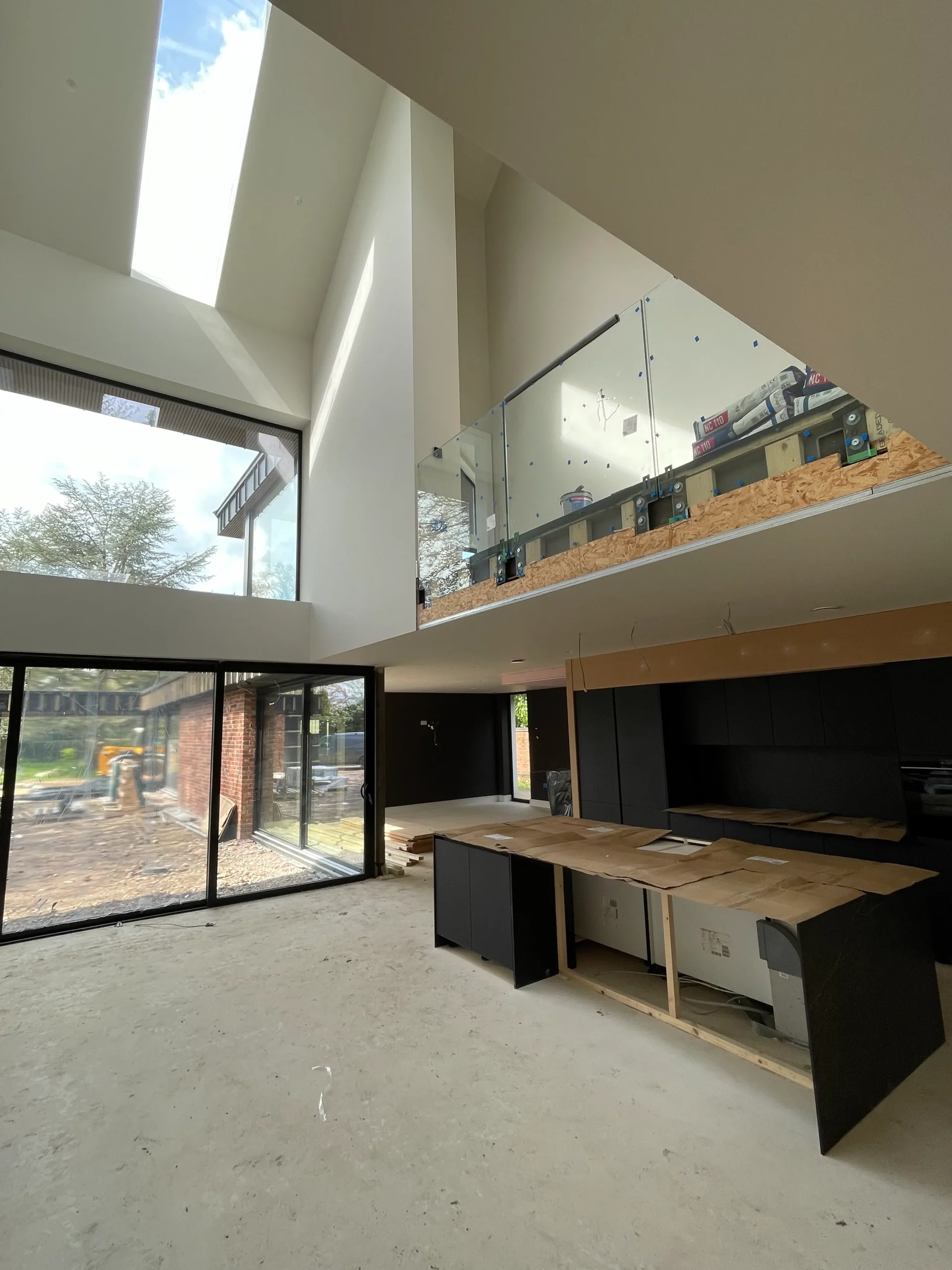 Internal view of atrium space linking dining, kitchen landing and games room beyond