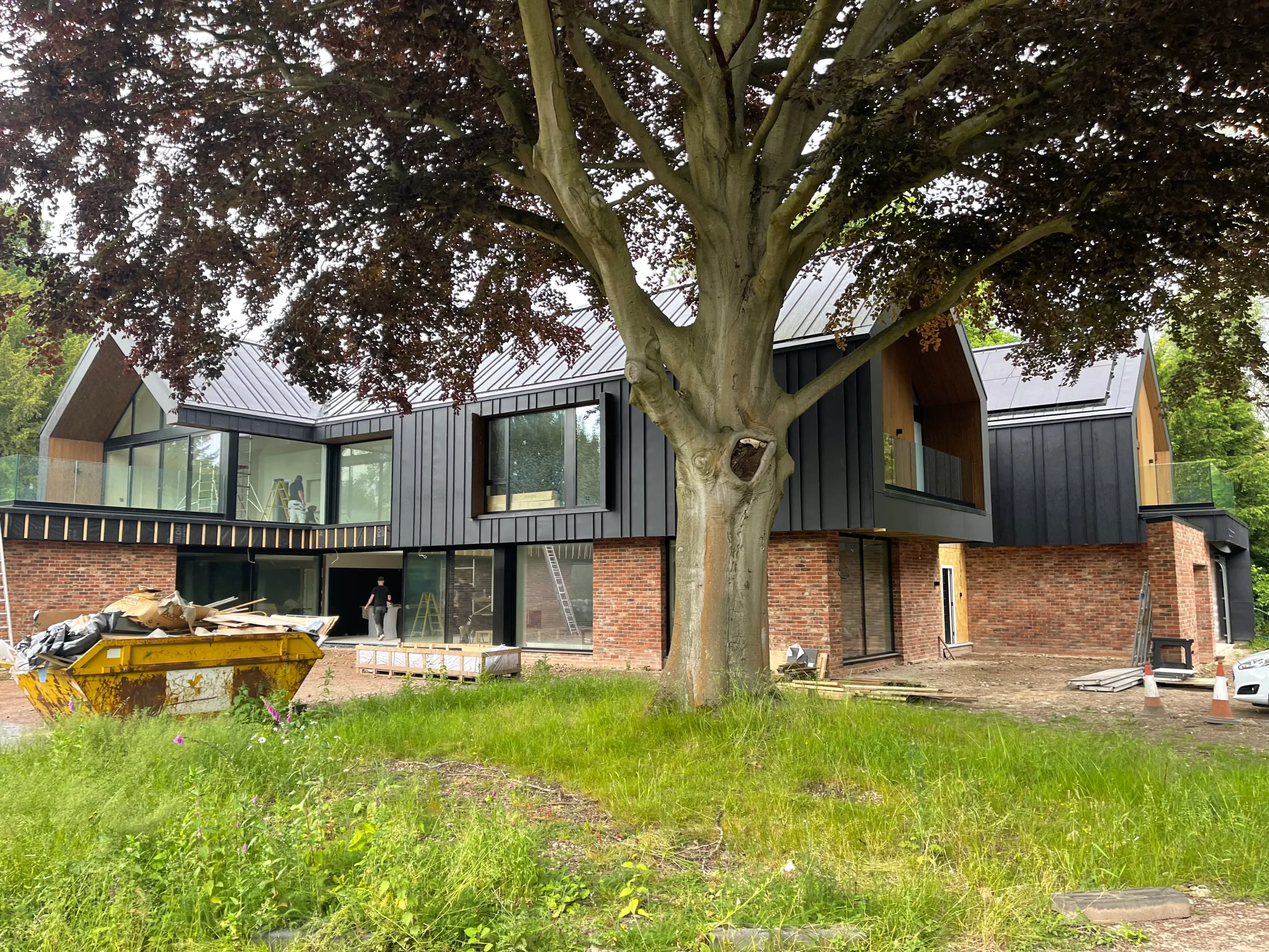 Oblique view showing red brick base supporting zinc clad upper tier
