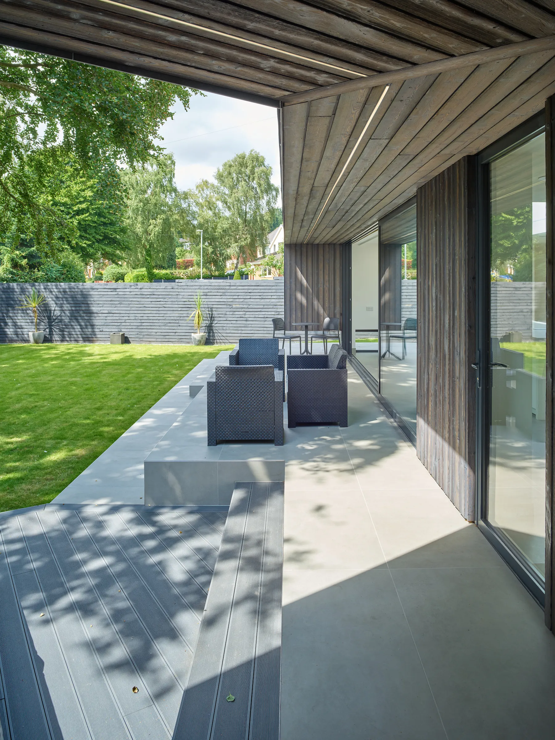 View across the raised terrace featuring a folding timber clad canopy above