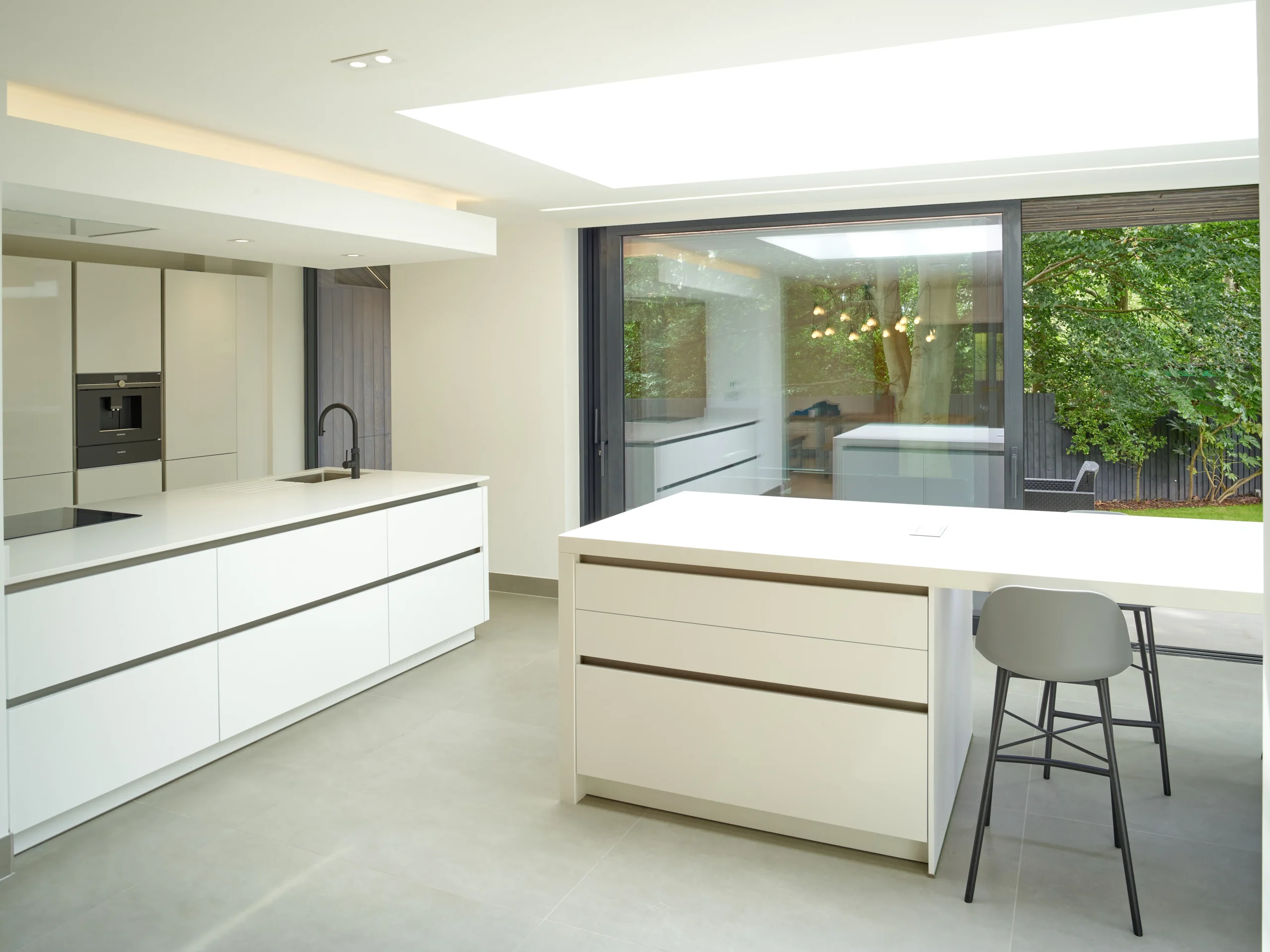 View of the kitchen with double island and large sliding doors