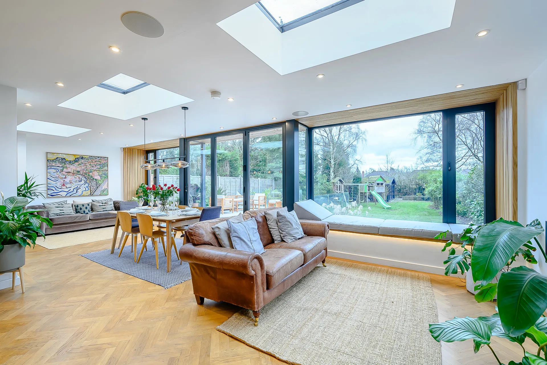 Open plan space linking lounge, dining and reading nook with views onto rear garden