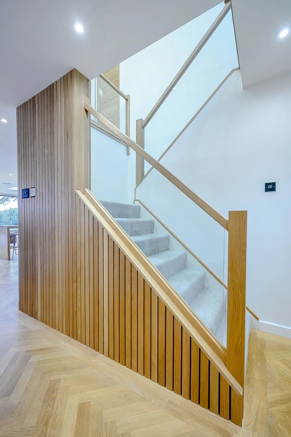 Existing stair rejuvenated with timber cladding and glass balustrade