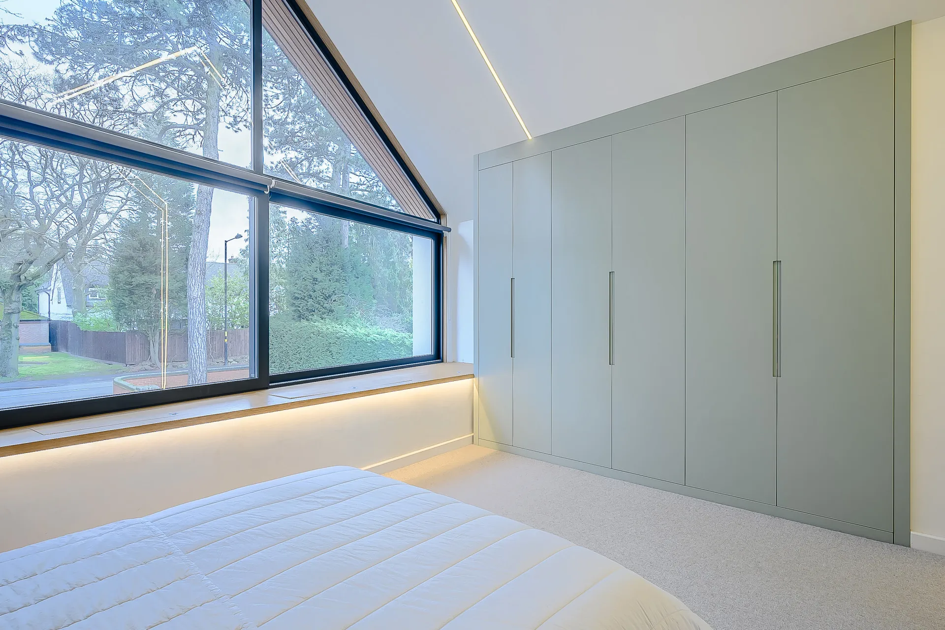 Master bedroom with vaulted ceiling, strip light and build in wardrobe.