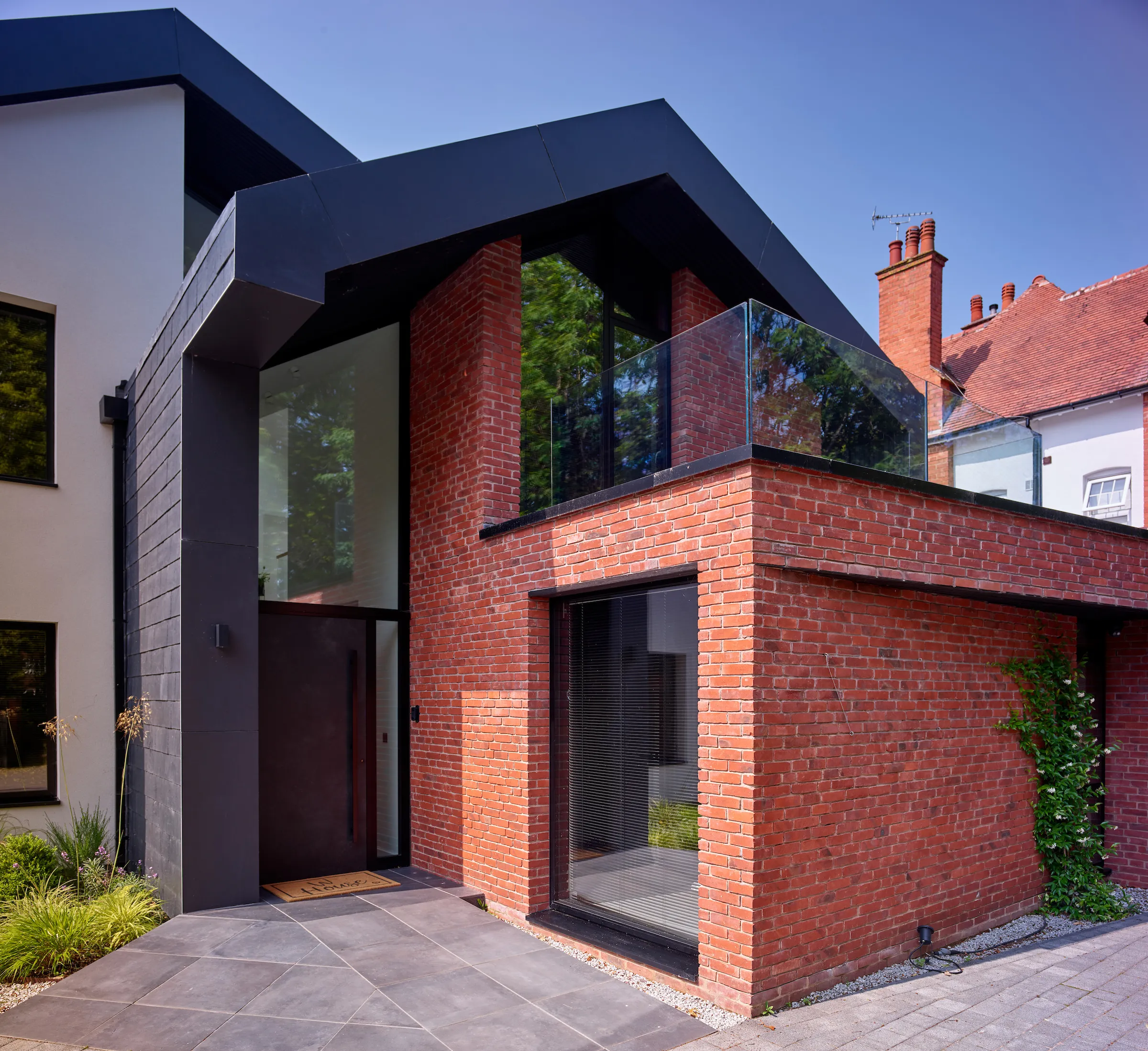 Front entrance with atrium glazing above and adjacent balcony