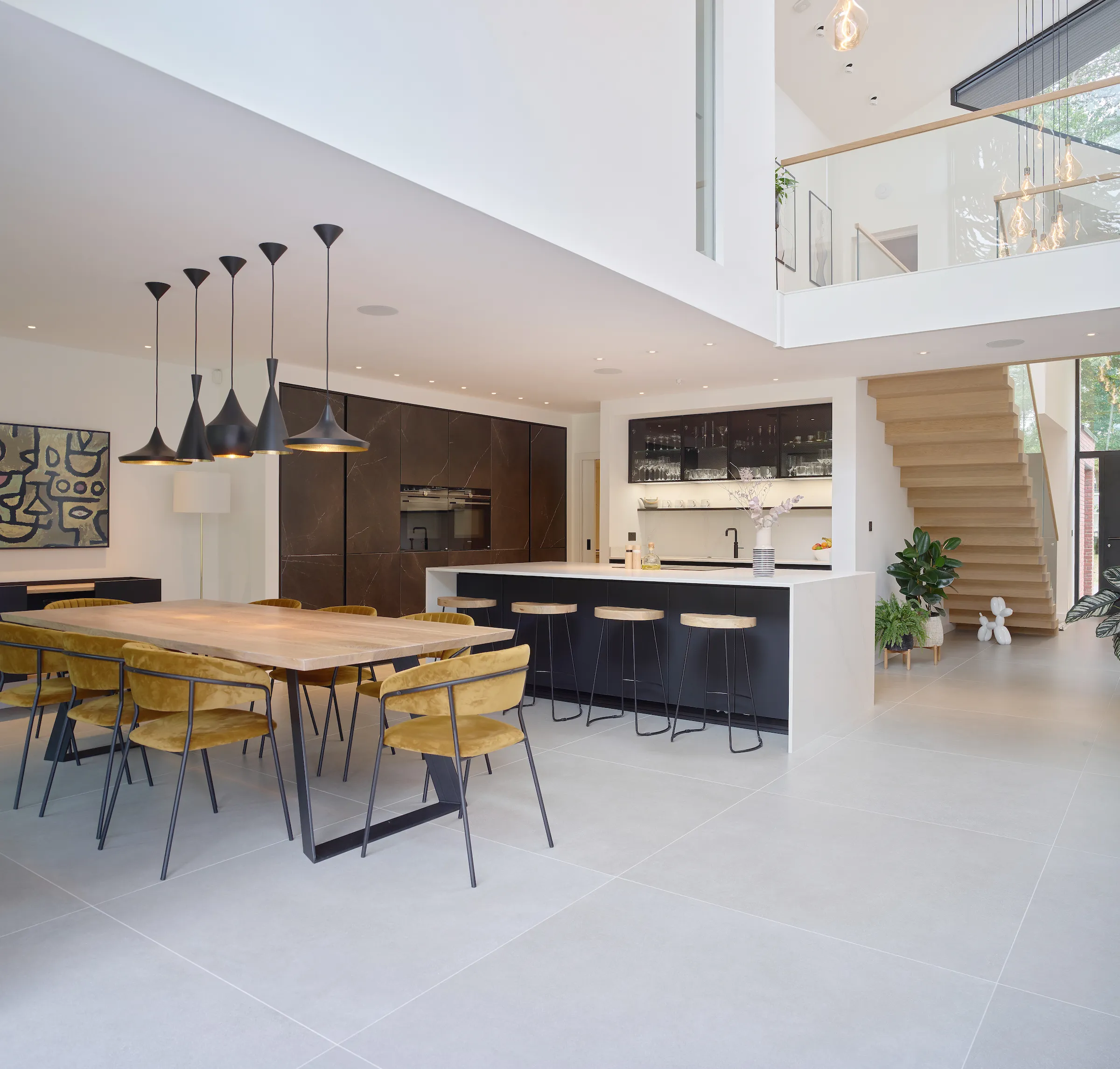 Open plan kitchen diner and atrium with interna bridge