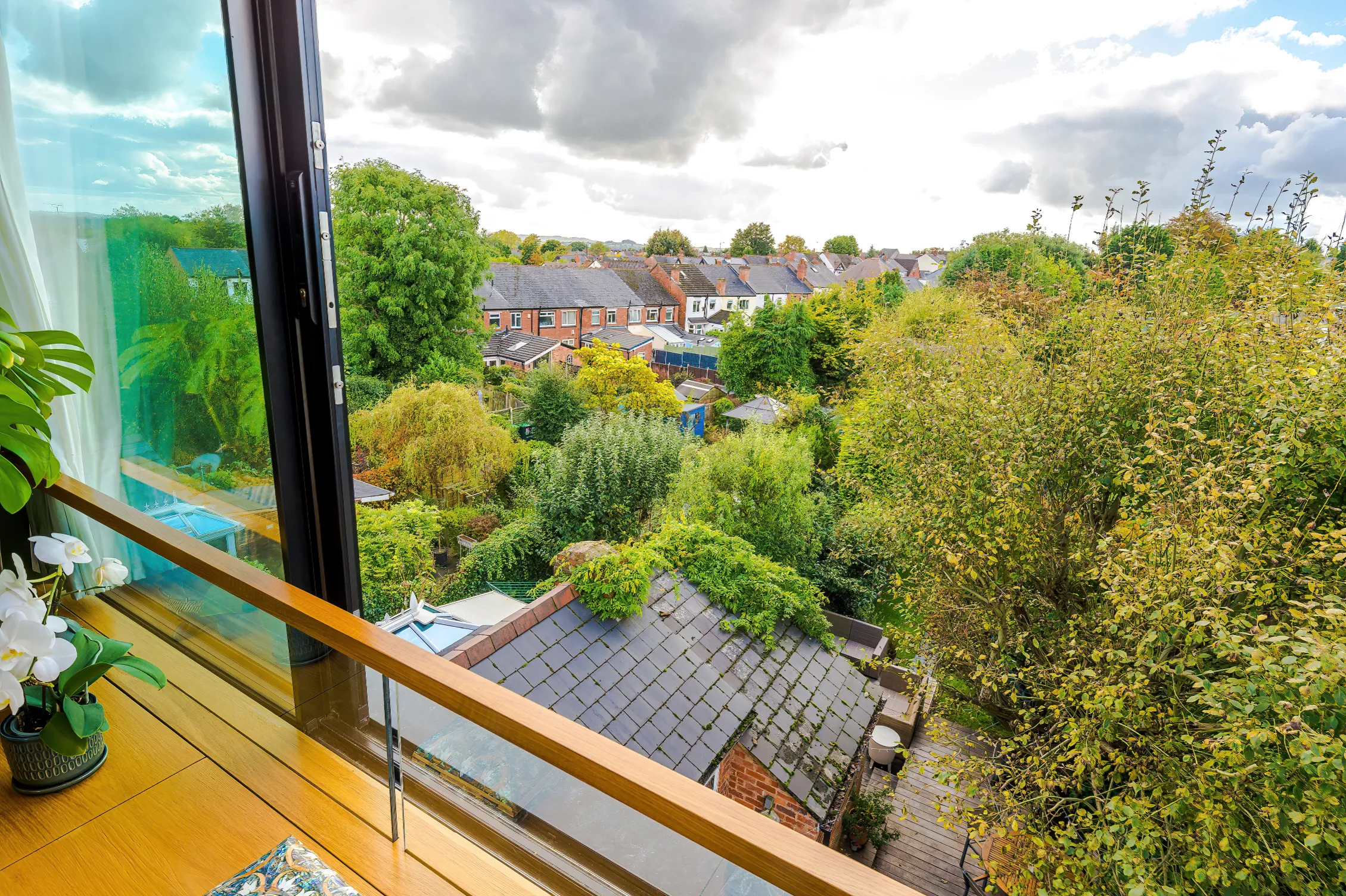 The loft room boasts fabulous views across rooftops and treetops, with a balcony-like feel when the sliding doors are open.
