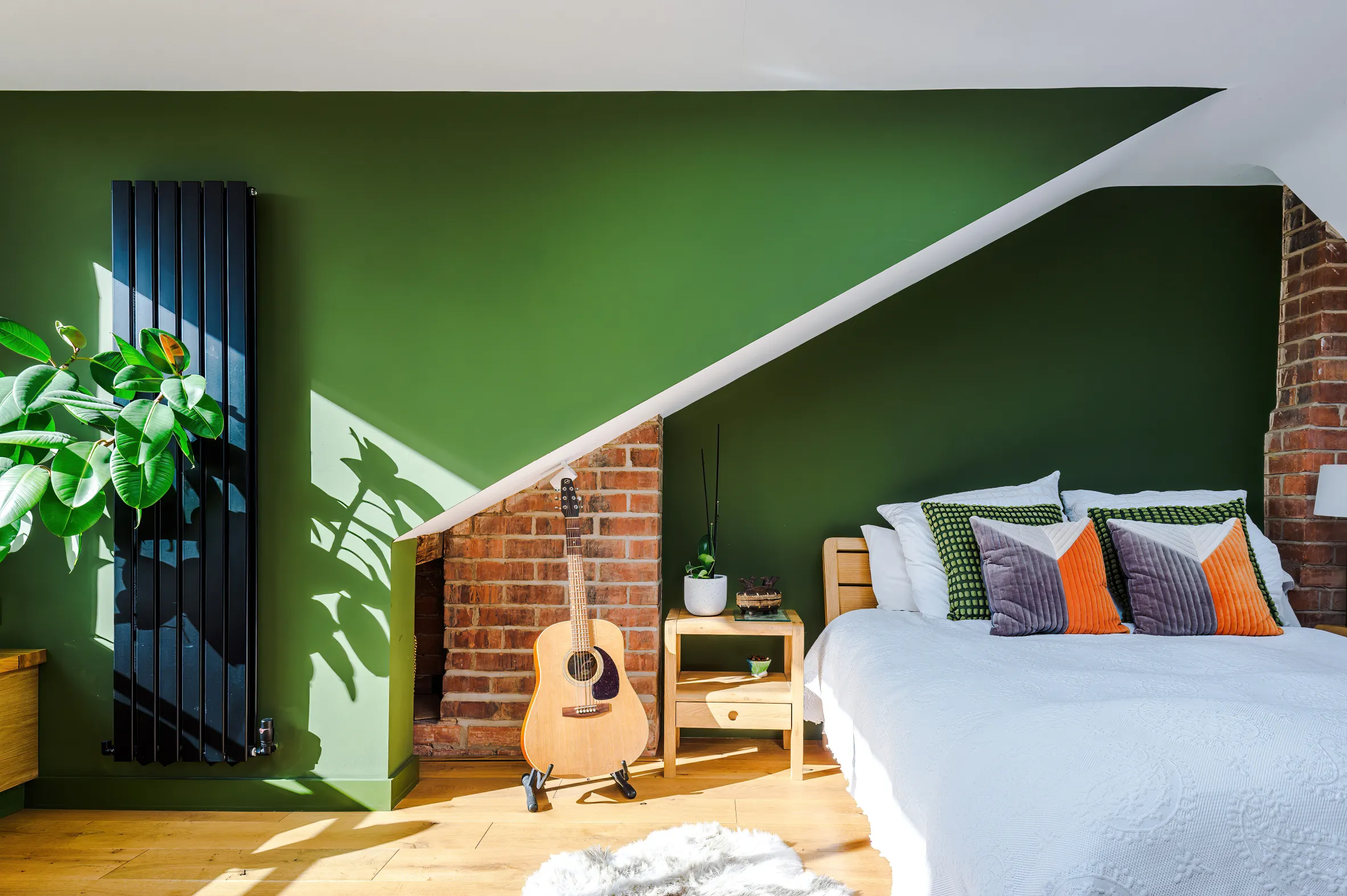 The loft room is characterised by its roof angles, exposed chimney breasts, and abundance of natural light.