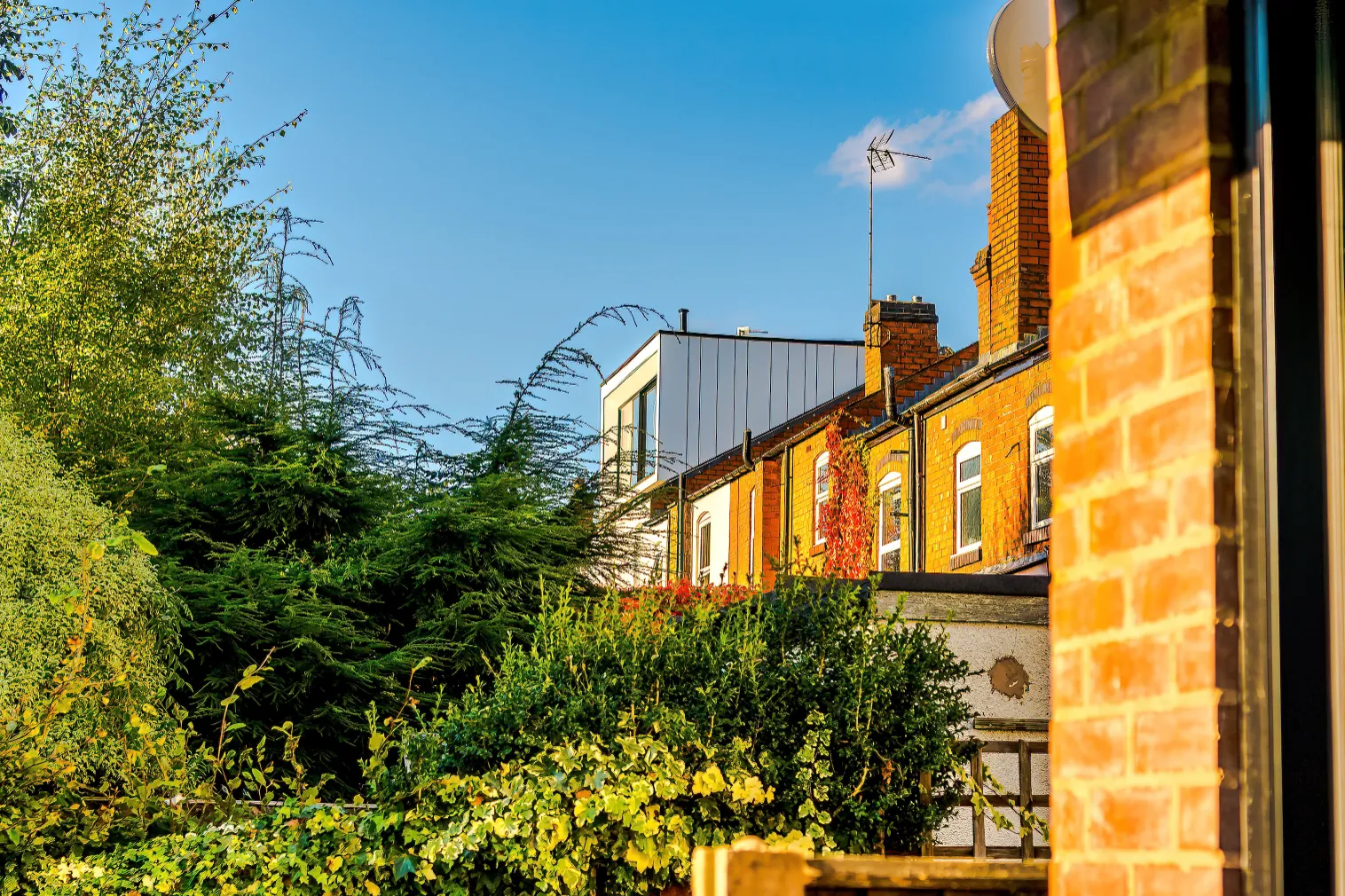 The loft dormer is clad in white panels of varying widths.