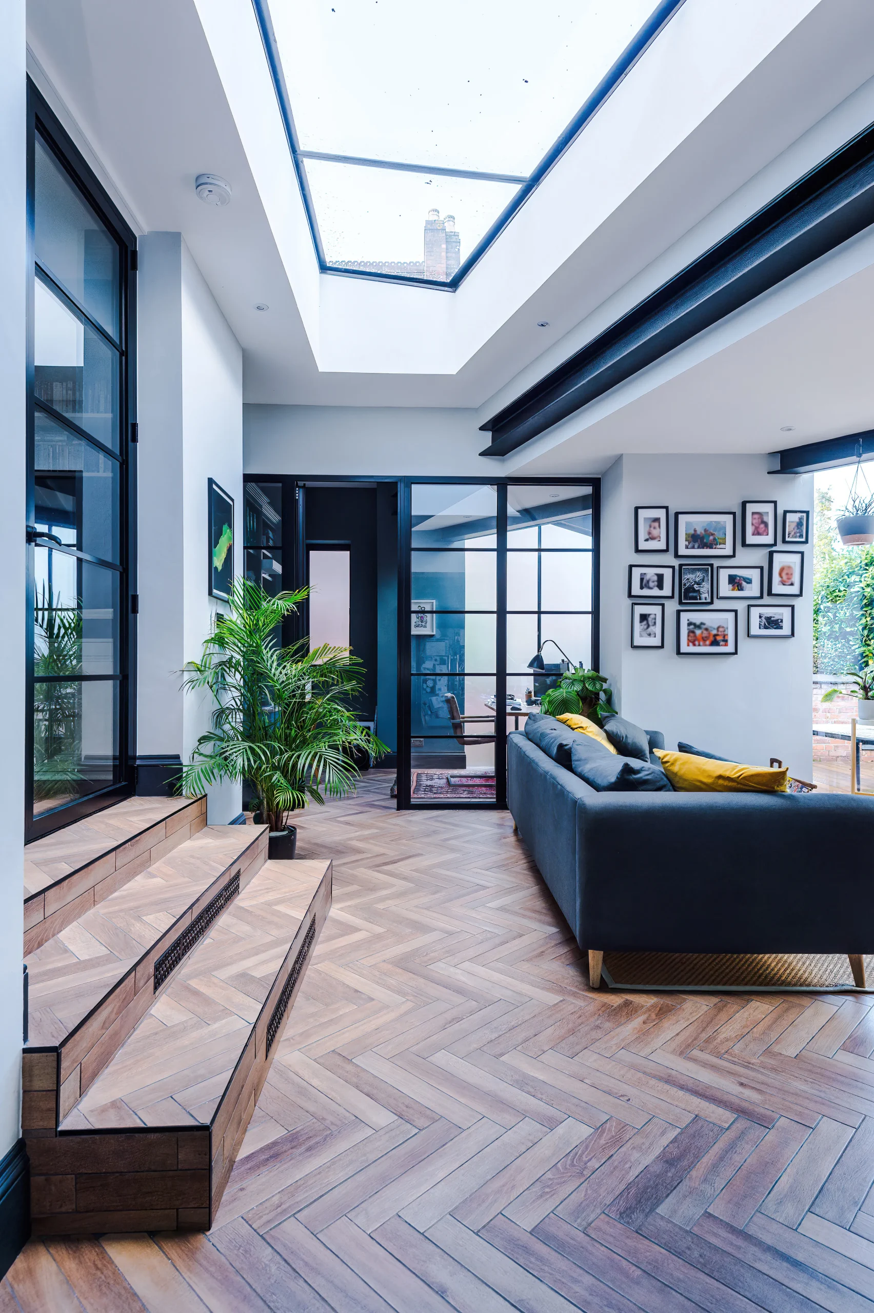 Crittall style glazed screens and exposed beams help create a contemporary space that complements the existing Victorian architecture.